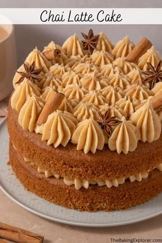 there is a cake with icing and star anise on the top that says chai latte cake