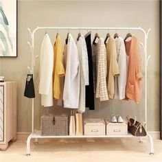 a rack with clothes and shoes on it in a living room next to a dresser