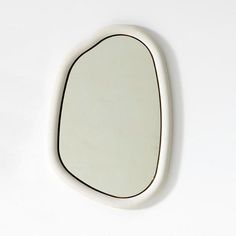 an oval mirror mounted to the side of a wall