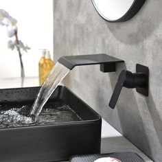 a bathroom sink with water running from the faucet and soap dispenser