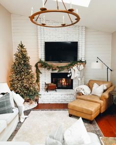 the living room is decorated for christmas with white brick walls and a large flat screen tv