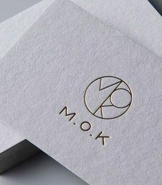 the monogrammed logo is on top of two folded paper