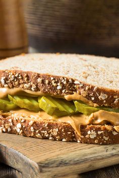 a sandwich with pickles and peanut butter on it