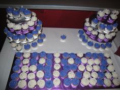 cupcakes are arranged on top of each other in purple and white frosting