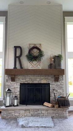 the fireplace is decorated with wreaths and other items on it's mantel