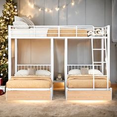 two white bunk beds sitting next to each other in a room with christmas lights on the wall