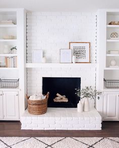 a living room filled with furniture and a fire place covered in white bookshelves