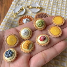 small miniature food items are placed on someone's hand