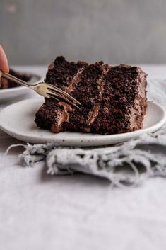 a piece of chocolate cake on a plate with a fork