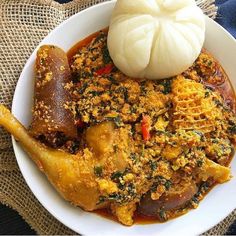 a white bowl filled with food on top of a table