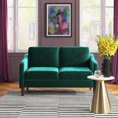 a living room scene with focus on the green couch and black and white striped rug