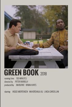 two men sitting at a picnic table talking to each other, with the text green book 2013 written below them