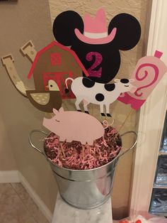 mickey mouse centerpieces in a bucket with farm animals and barnyard cutouts