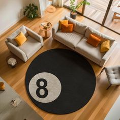 an overhead view of a living room with a black and white 8 - ball rug