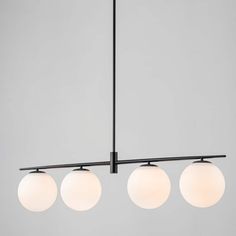 three light chandelier with white globes hanging from the ceiling in a room