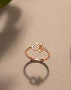 a close up of a ring on a table next to a vase with flowers in it