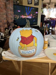 a winnie the pooh pumpkin sitting on top of a table