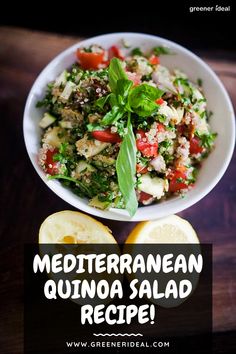 mediterranean quinoa salad recipe in a white bowl with lemons and basil on the side