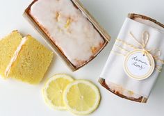 two slices of lemon pound cake next to a jar of jam and sliced lemons