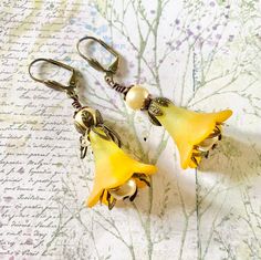 Yellow Flower Earrings, Yellow Plant Earrings, l Yellow Fairy Earrings, Romantic Earrings, Birthday Gift For Her, Gift For Girlfriend  Stand out from the crowd with these stunning Yellow flower Earrings, so colourful and eye catching.  These Lucite flowers are painted by hand and lovingly paired with antique brass and cream faux pearls. They are suspended on brass lever Back ear wires that are secure and wont fall out.  Perfect earrings for summer, weddings and parties. Ideal gift for someone sp Whimsical Flower Charm Earrings For Gift, Whimsical Gold Flower-shaped Earrings, Whimsical Yellow Jewelry With Ear Wire, Whimsical Flower Shaped Earrings Gift, Yellow Ear Wire Earrings For Wedding, Yellow Earrings With Ear Wire For Wedding, Yellow Wedding Earrings With Ear Wire, Yellow Flower Earrings For Wedding, Handmade Yellow Flower Earrings For Wedding