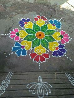 a colorful flower design painted on the ground