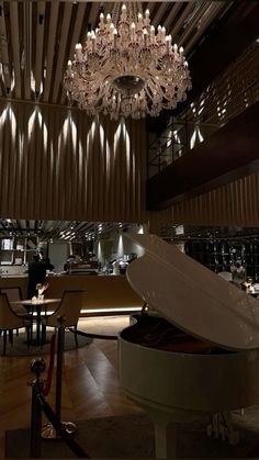 a grand piano and chandelier in a restaurant