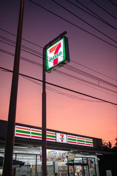 a gas station sign is lit up at dusk