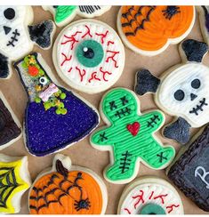 decorated cookies are arranged in the shape of witches, pumpkins and ghost faces for halloween