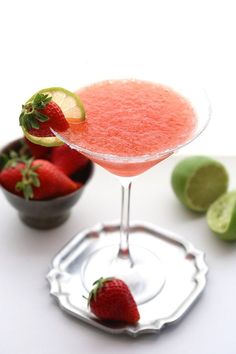 a strawberry margarita sitting on top of a white table