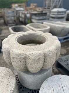 several cement vases sitting on top of each other