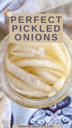 a jar filled with pickled onions sitting on top of a blue and white table cloth