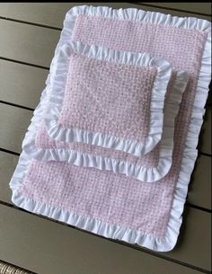 two pink and white bedspreads with ruffled edges