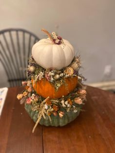 a small pumpkin sitting on top of a wooden table