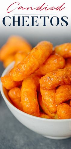 a white bowl filled with fried cheetos on top of a table