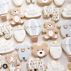 baby shower cookies with teddy bears, hot air balloons and other decorations on a table