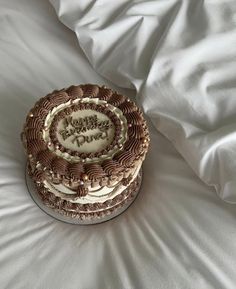 a decorated cake sitting on top of a white bed