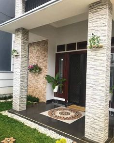 the front entrance of a house with grass and flowers