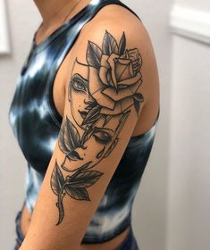 a woman with a rose tattoo on her arm