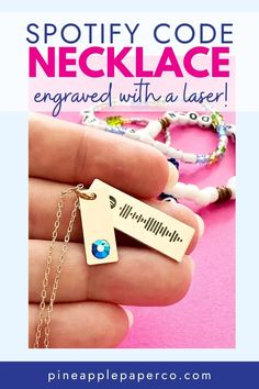 a hand holding a necklace with the words spotty code necklace engraved on it and an arrow