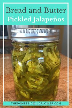 a jar filled with pickles sitting on top of a wooden table