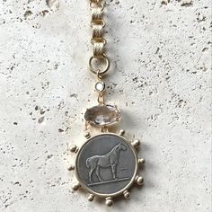 Expertly crafted and designed for longevity, the Parsons Gold Horse Coin Necklace is the perfect accessory for any equine enthusiast. This French Coin Pendant has a vintage timeless vibe. Complete your look with this unique and elegant piece. Parsons Gold Horse Coin Necklace Genuine Crystal Quartz Connector Length 32" Coin Pendant Approximate Size 30mm MADE IN USA Elegant Medallion Coin Necklace With Vintage Charm, Bohemian Medallion Coin Necklace, Engraved, Vintage Gold-tone Coin Necklace, Children Bottoms, Horse Coin Necklace, Classic Horse Design Pendant Necklace, Authentic Turquoise Jewelry, French Coins, Gold Horse