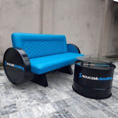 a blue couch sitting next to a black table