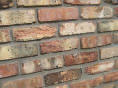 an old brick wall with rusted paint and chippings on the edges is seen in this image