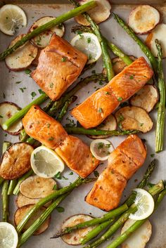 salmon, asparagus and potatoes on a baking sheet