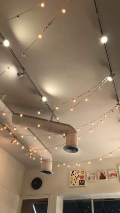 some lights are hanging from the ceiling in a room