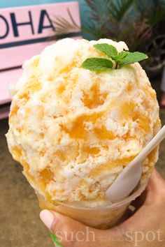 a person holding an ice cream sundae in their hand