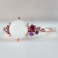 Beautiful handmade item! Here, on Etsy made as simulation only-just resin and white color.  Breastmilk Ring made with white gold plated sterling silver or plated with rose or yellow gold. Opal effect breastmik 7mm diamond shaped stone. Any size available. Rose gold,  or white gold plated options.  Pearl powder or opal effect can be added to this fine breastmilk ring.  Symbolic of the little diamond you brought into this world, our breastmilk stone ring shines bright. Beautiful inlaid cubic zirconia surround and accentuate your breastmilk stone while a skin-friendly 925 sterling silver ring core.  To see our full breastmilk Ring collection, please click here: https://www.etsy.com/ca/shop/KeepsakeMom?ref=simple-shop-header-name&listing_id=1095328032&section_id=24695275 To see All our items, White Opal Birthstone Ring In 14k Gold, 14k Gold White Opal Birthstone Ring, White Opal Dainty Birthstone Ring, White Opal Birthstone Promise Ring, White Dainty Opal Birthstone Ring, Fine Jewelry White Opal Birthstone Ring, White Opal Birthstone Ring In Dainty Style, White Dainty Opal Gemstone Ring, White Dainty Opal Ring