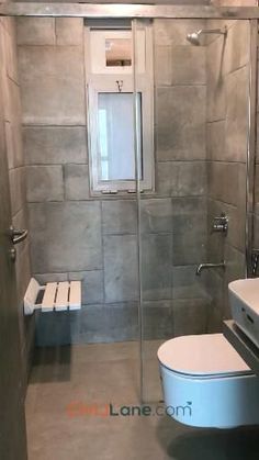 a bathroom with a toilet, sink and shower stall