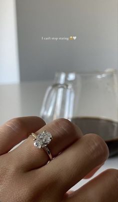 a woman's hand with a diamond ring on it