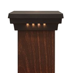 a wooden post with three lights on the top and one light at the end,